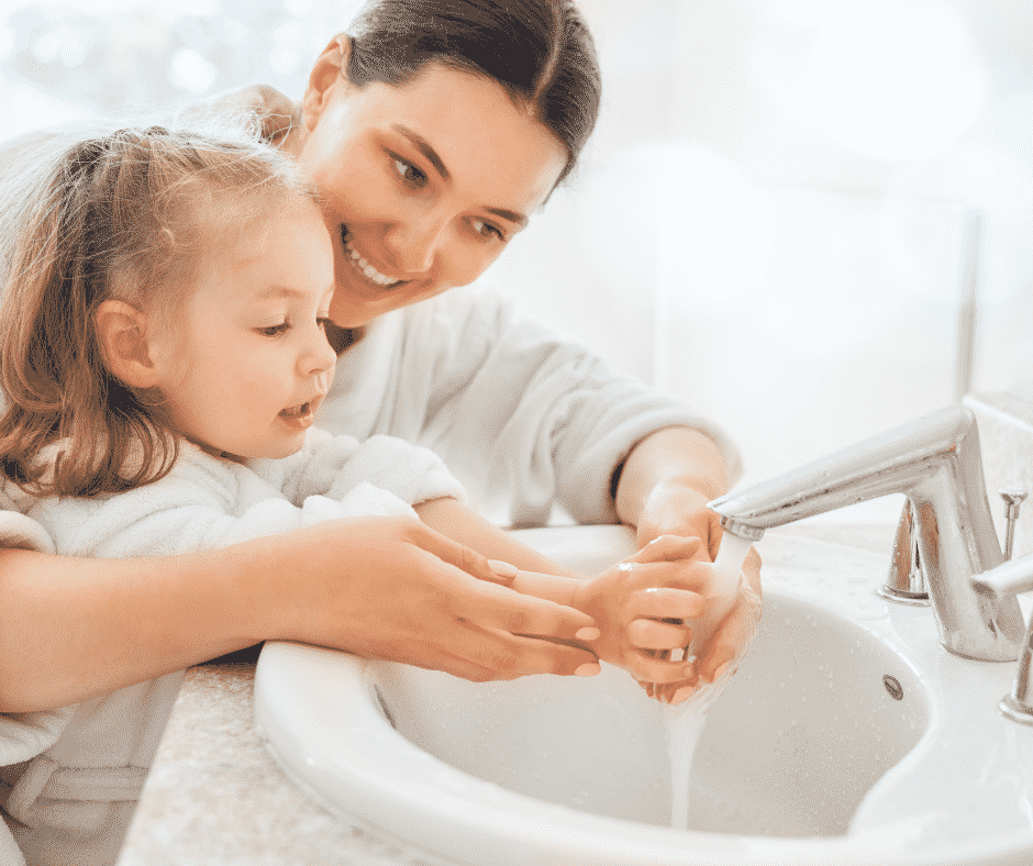 A mother helping her daughter wash her hands thanks to a quality thermostatic mixing valve